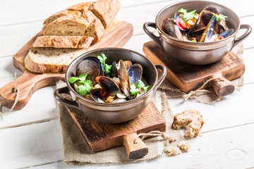 Mussels in shells with garlic sauce served with bread