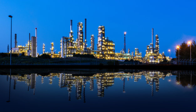 Modern factory reflected in a lake at night