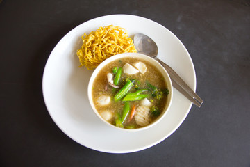 Fried noodle with pork and kale soaked in gravy - Stock Image