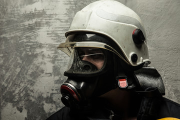 Fototapeta premium Firefighter in helmet and oxygen mask