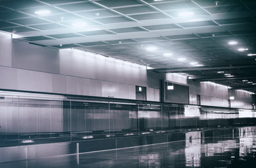 View of airport interior with escalator.