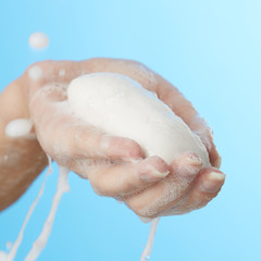 Female hand in foam of shower gel with soap
