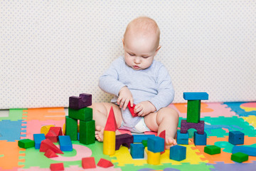 Cute little baby playing with colorful toys