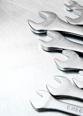 Wrenches on the scratched metal background.