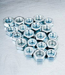 Nuts on scratched metal background.