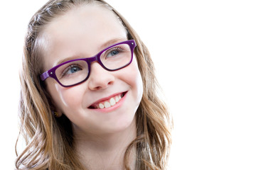 Cute girl with glasses looking at upper corner.