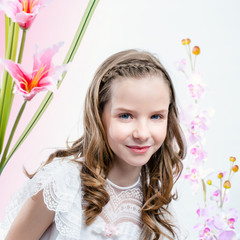 Obraz na płótnie Canvas Young girl in white dress among flowers.