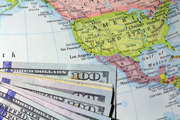 Money atop an old atlas