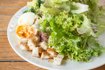 Homemade salad serving on wooden background