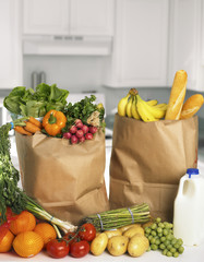 Assorted fruits and vegetables in brown grocery bag © Korta