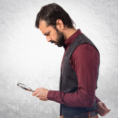 Man wearing waistcoat with magnifying glass