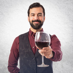 Man wearing waistcoat holding a wine glass