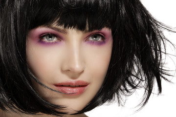 Beauty model hairstyled  and pink eye shadows makeup  closeup
