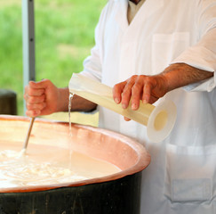 RENNET in milk in copper pot for making cheese