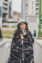 Obraz premium Beautiful young brunette posing in the city streets