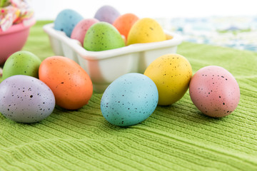 colored Easter eggs in white carton