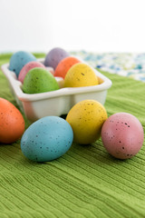 colored Easter eggs in white carton