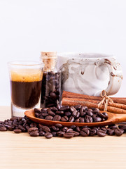 A Coffee cup and coffee beans on  wooden panel - With copy space