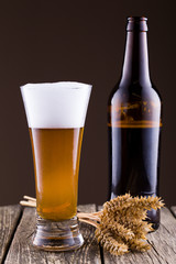 Beer bottle with a glass and spica