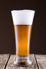 Beer glass in a golden background.