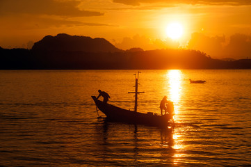 Sunset at traditional fishing boat in Koh Phitak island.