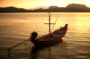Fototapeta premium Sunset at traditional fishing boat in Koh Phitak island.