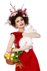 woman with a bunny, eggs and flowers spring easter concept