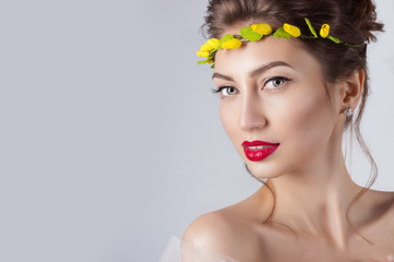 elegant woman with red lips with wreath of yellow roses on head