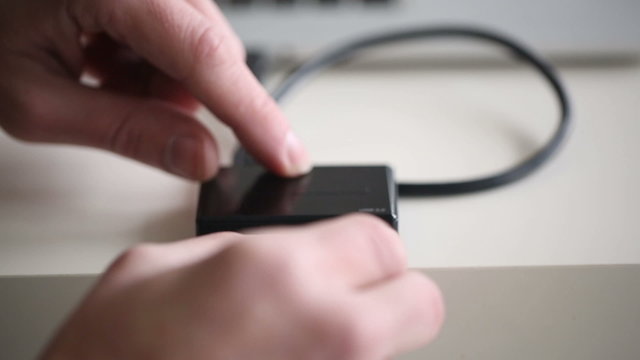 Hand inserting SD card 16Gb in memory card reader