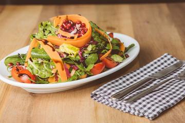 Salat auf kleinem Teller mit Messer und Gabel