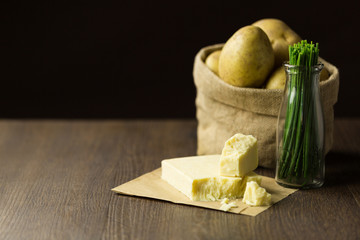 Baked potatoes in a sack with chives and mature cheddar cheese