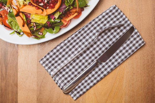 Salat auf kleinem Teller mit Messer und Gabel // Oben Ansicht