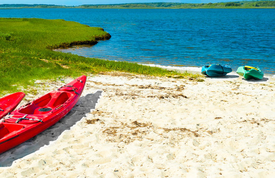 Colorful Kayaks Pulled Up Onto The Sand