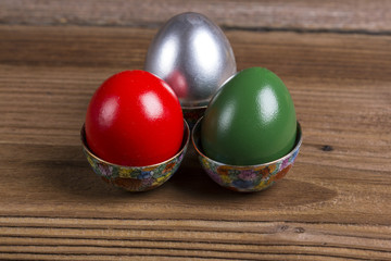 Colourful Easter eggs in ornamented cups