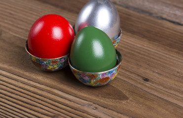 Colourful Easter eggs in ornamented cups