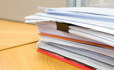 pile of documents on the office desk