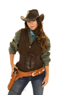 cowgirl with gun and holster hand on gun