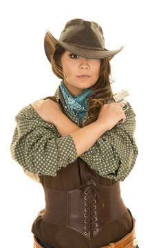 cowgirl with gun and holster arms crossed looking