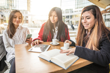 Friends looking at mobile phone in a bar