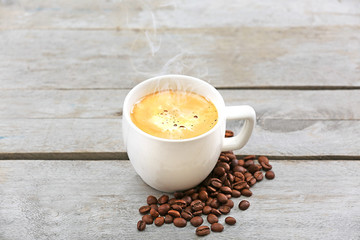 Cup of coffee on wooden table, close up