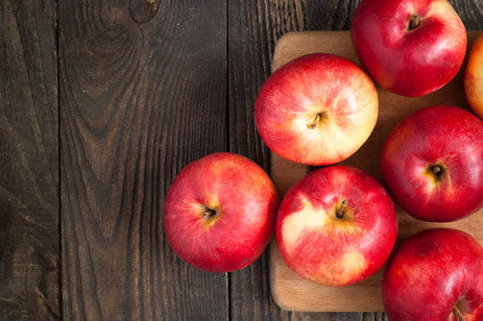 Some red apples on the board