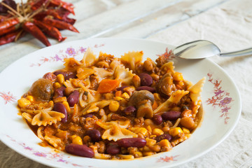 Chili con carne with pasta in plate