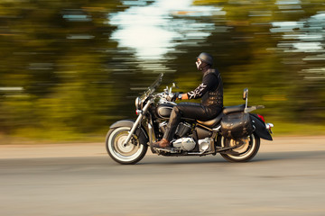 Fototapeta na wymiar slow motion, biker riding motorbike with blur movement, speed co