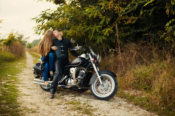 Naklejka na ściany i meble Young couple with beautiful bike on road.