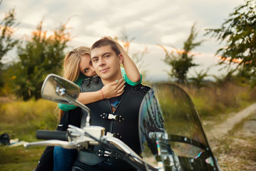 Fototapeta na wymiar Young couple with beautiful bike on road.