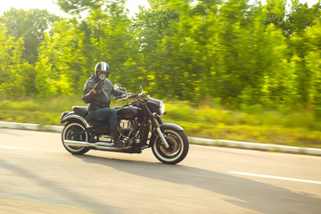 Obraz na płótnie Canvas slow motion, biker riding unknown motorbike with blur movement,