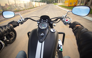 Driver riding motorcycle on an asphalt road
