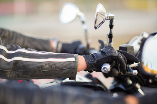 Biker hand rests on the steering wheel motorcycle