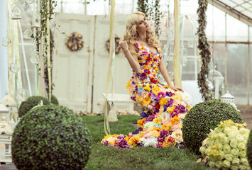 Fashion lady in spring scenery wearing flower dress