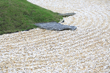 Zen stones with green grass in the garden